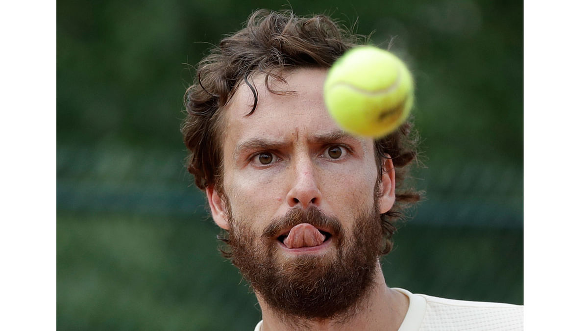 Latvia’s Ernests Gulbis eyes the ball as she plays Luxembourg’s Gilles Muller during their first round match of the French Open tennis tournament at the Roland Garros stadium 28 May in Paris. Photo: AP