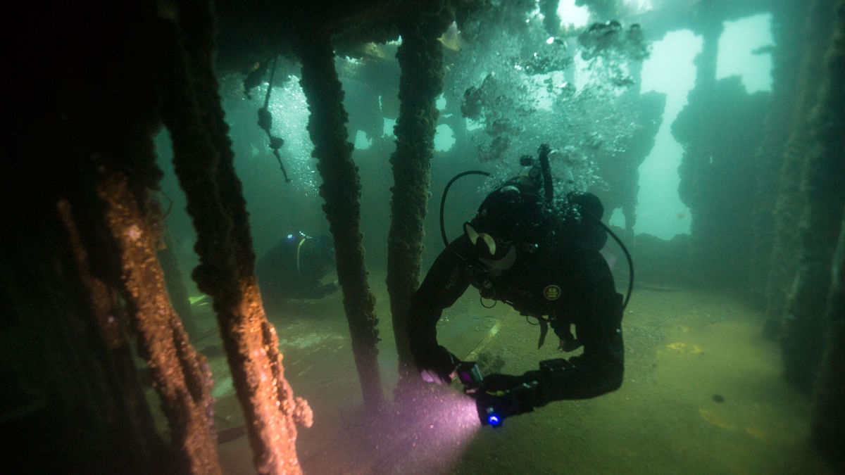 A diver takes video while exploring a sunken boat on the Ancon coast on the outskirts of Lima, Peru on 27 March. Photo: AP