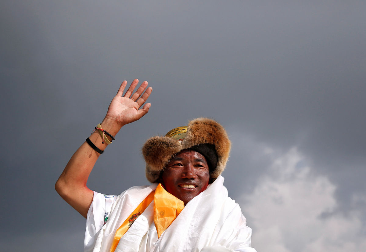 Kami Rita Sherpa, 48, a Nepali mountaineer waves towards the media personnel upon his arrival after climbing Mount Everest for a 22nd time, creating a new record for the most summits of the world`s highest mountain, in Kathmandu, Nepal on 20 May 2018. Photo: Reuters