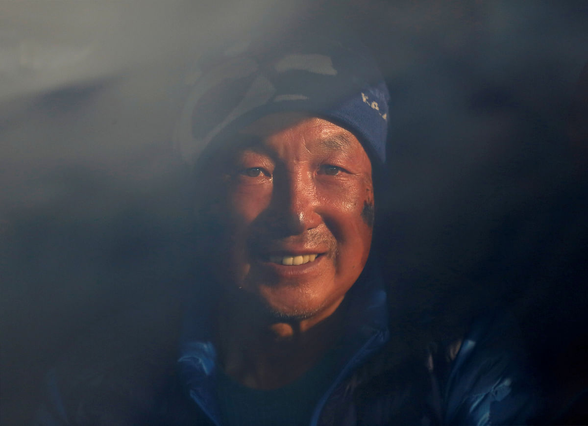 Xia Boyu, a Chinese double amputee climber, who lost both of his legs during his first attempt to climb Everest, smiles as he sits on an ambulance upon his arrival, after successfully climbing Mount Everest, in Kathmandu, Nepal on 16 May 2018. Photo: Reuters