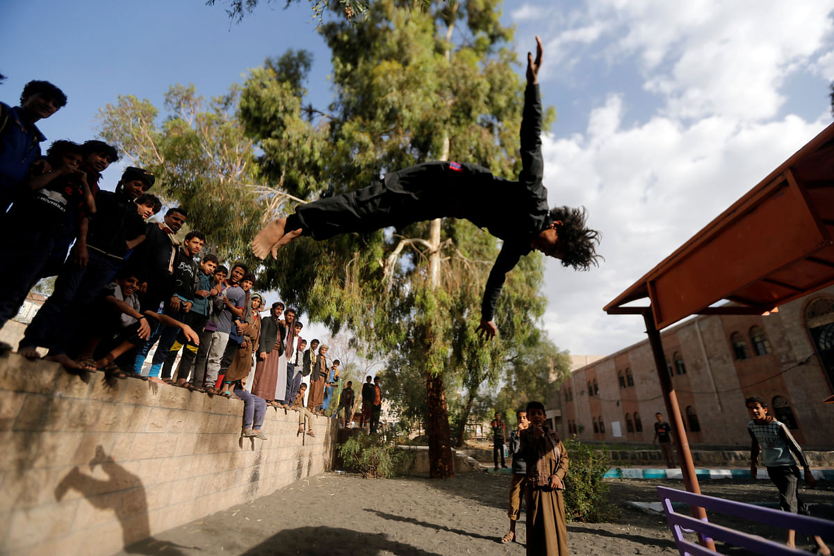 A boy performs acrobatics at the yard of an orphanage in Sanaa, Yemen on 30 May, 2018. Photo: REUTERS