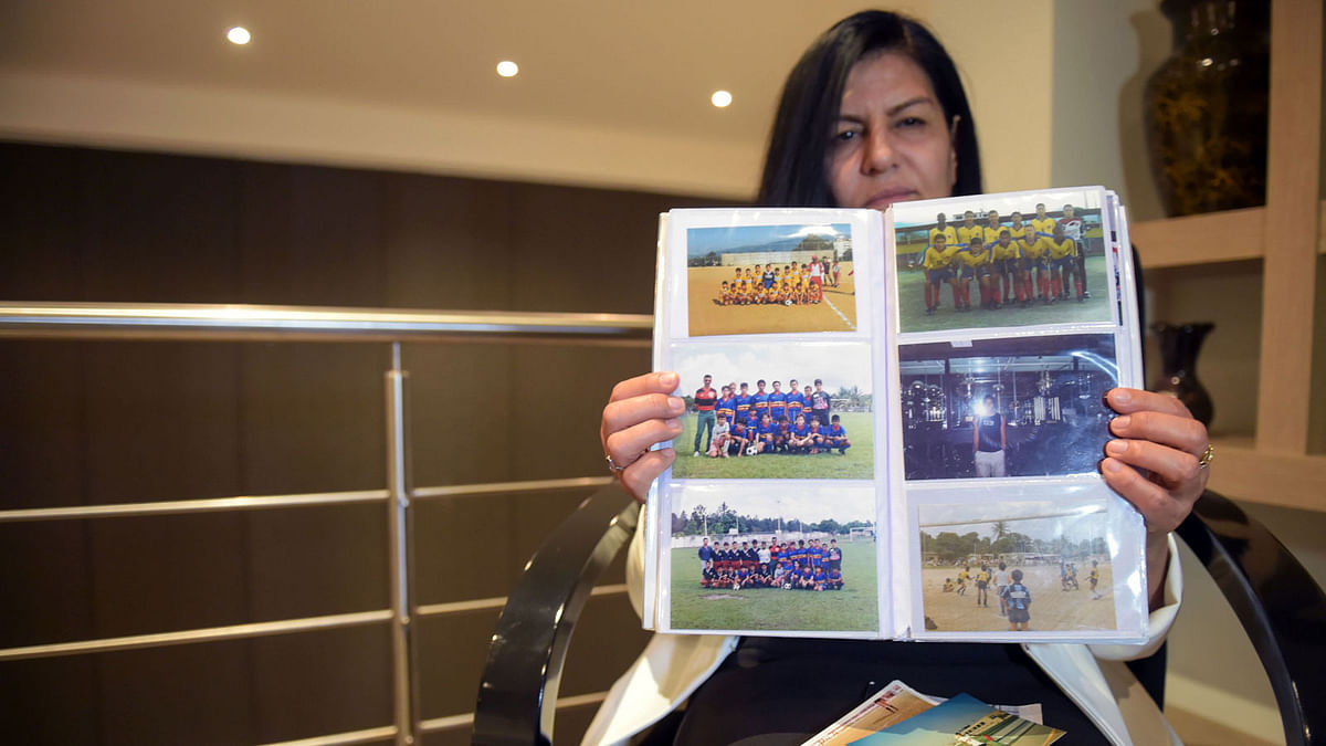 Juana Zarate, mother of Colombian national team football player Radamel Falcao, shows pictures of his son from a family album, during an interview with AFP at her house in Chia near Bogota, on May 12, 2018. He could have made history in baseball, but the most popular sport in the world won his heart, now Colombian Radamel Falcao, is in the countdown to fulfil his dream of playing a World Cup. Photo: AFP