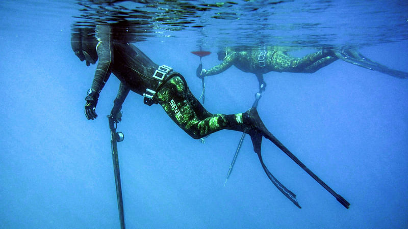 Lebanese freedivers Rachid Zock (L) and Jamal Hilal hold spearguns as they start to dive off of the coast of Qalamun in northern Lebanon, on 4 March 2018, in a bid to promote regulated spearfishing and raise awareness against fast-depleting aquatic wildlife.