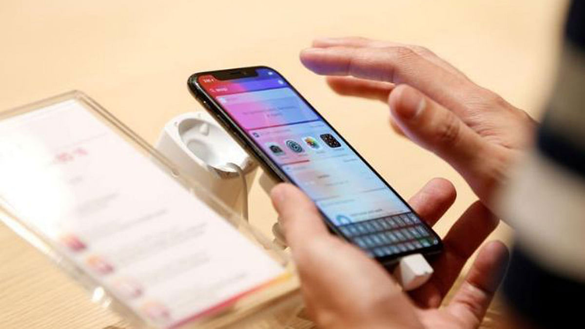 A customer tests the features of the newly launched iPhone X at VIVA telecommunication store in Manama, Bahrain, on 3 November 2017. Photo: Reuters