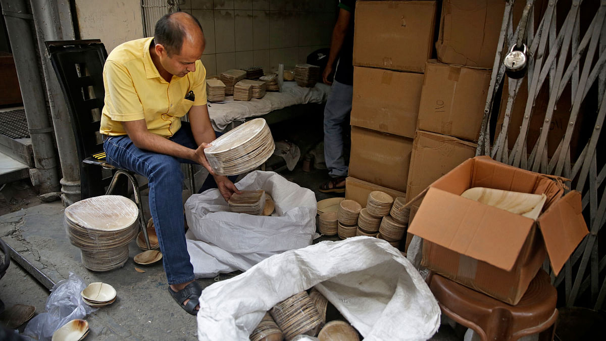 In this photo taken on 28 May 2018, Sanjay Aggarwal, inspects the products he purchased from Prakritii, or nature, a company that manufactures eco-friendly dinnerware at the company`s warehouse in New Delhi, India. Photo: AP