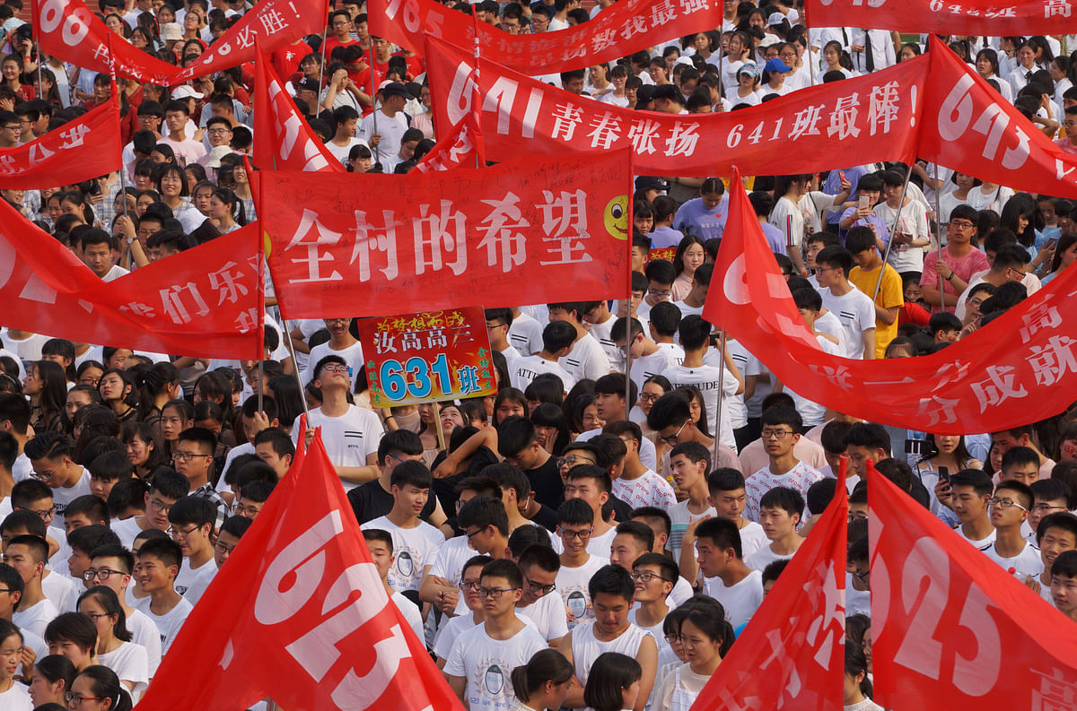 Students attend an oath-taking rally held on the graduation day, ahead of the annual national college entrance examination, or `gaokao`, at a high school in Zhumadian, Henan province, China on 3 June 2018. Photo: Reuters