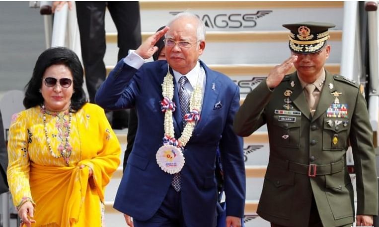 Malaysian prime minister Najib Razak salutes the honour guards, next to his spouse Rosmah Mansor, upon their arrival to attend the Association of Southeast Asian Nations (ASEAN) Summit and related meetings in Clark, Pampanga, northern Philippines on 12 November, 2017. Photo: Reuters