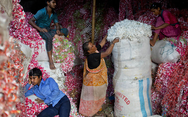 Bangladeshis work at a plastic strips storehouse in Dhaka, Bangladesh on 4 June. Photo:AP