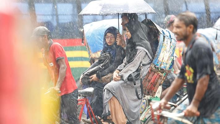 Passengers on a rickshaw and the rickshaw-puller get wet as it starts to rain suddenly. Kakrail, Dhaka, 4 June. Photo: Sumon Yusuf