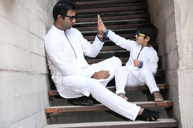 Father and son in white panjabi. Dress: Lubnan