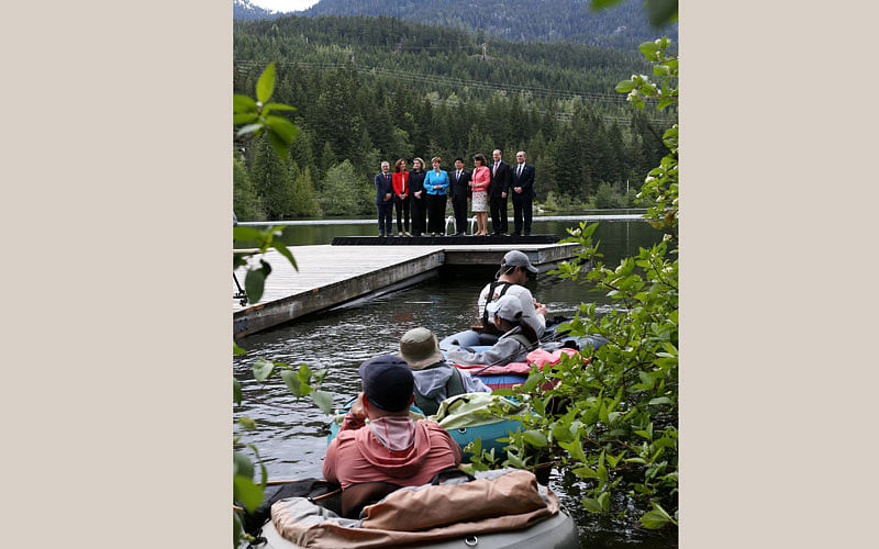 G7 delegates pose for a family photo near people fly fishing on Nita Lake at the G7 Finance Ministers summit in Whistler, British Columbia, Canada, 31 May 2018. Photo: Reuters