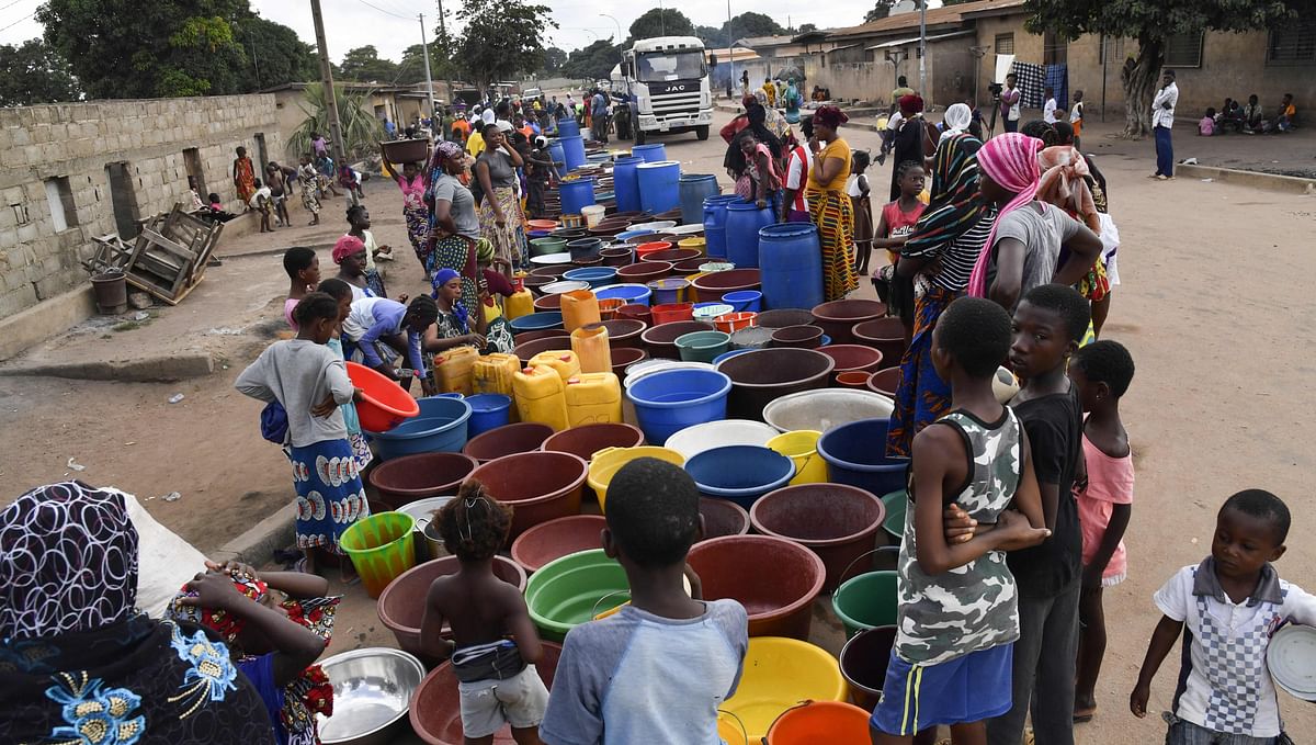 Residents wait as workers of the National Office of Drinking Water (ONEP) distribute water to the population on 2 June 2018 in a district of Bouake, central Ivory Coast, where the largest dam of the `Societe de Distribution de l`Eau de la Cote d`Ivoire` (SODECI - Water Distribution Company of Ivory Coast) has dried for several weeks. Photo: AFP