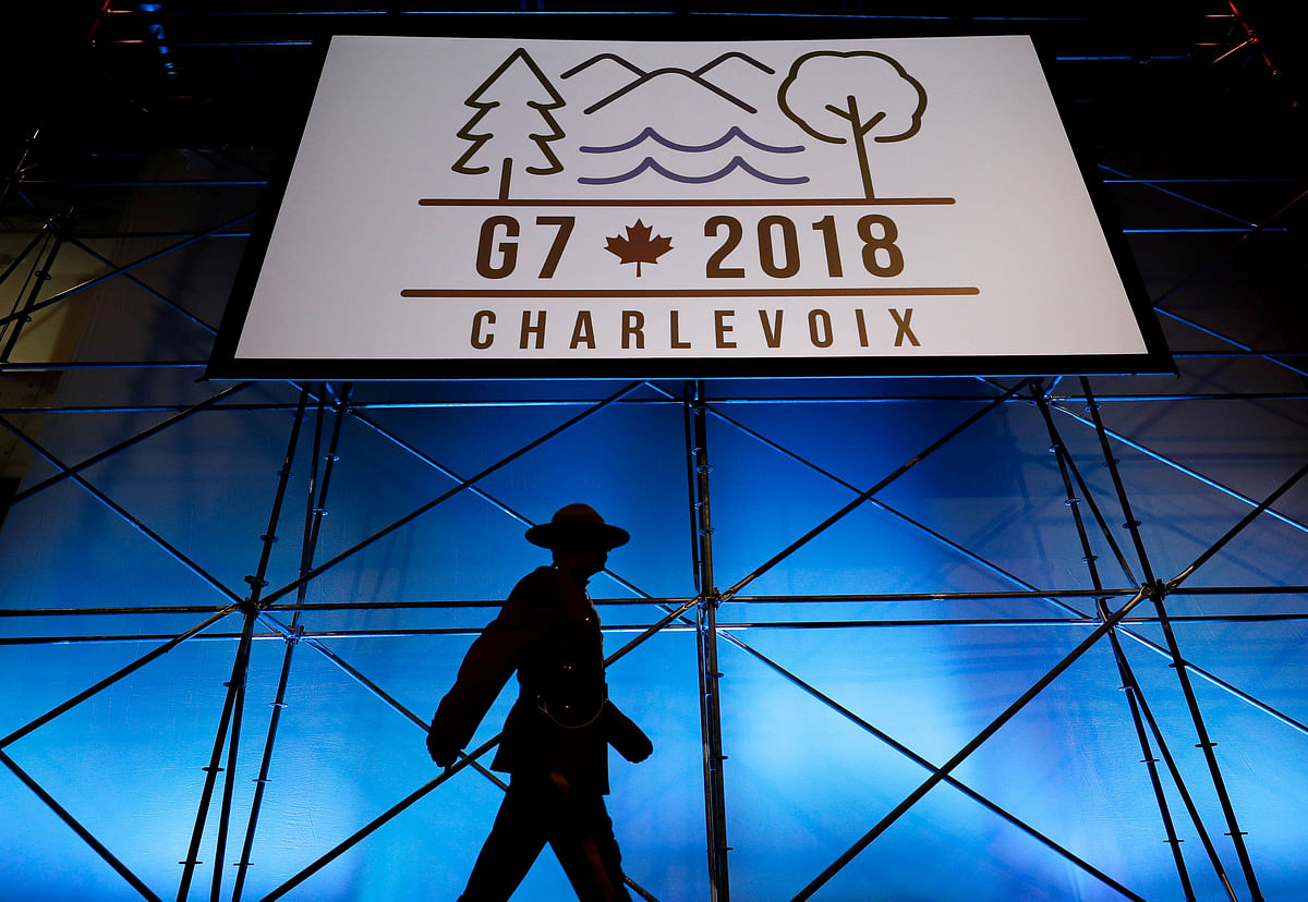 A Canadian mounted police officer walks past the Charlevoix G7 logo at the main press centre, ahead of G7 Summit in Quebec, Canada on 6 June 2018. Photo: Reuters