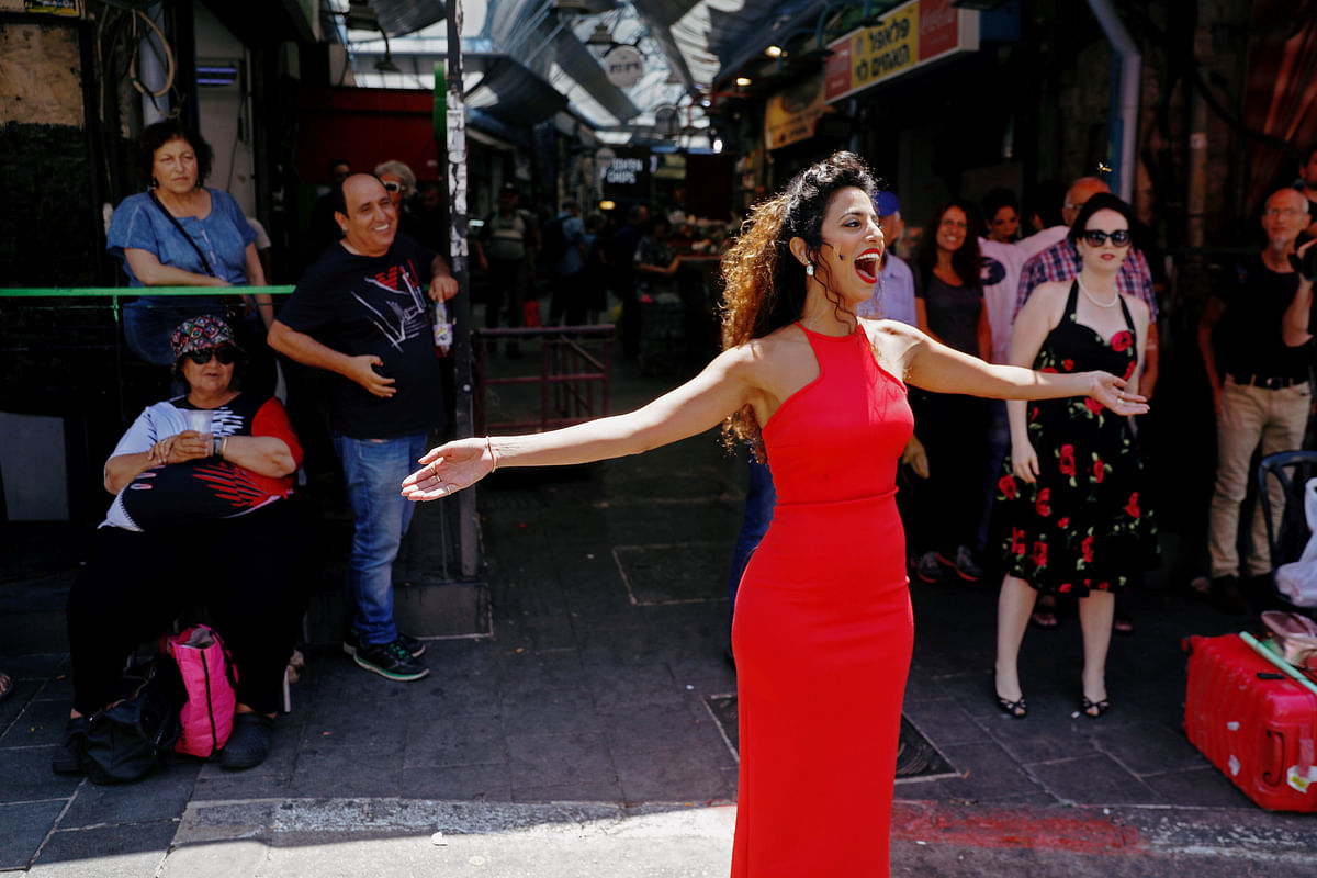 A soloist from the Israeli Opera sings during an open rehearsal of Giacomo Puccini`s `Madama Butterfly` at the Mahane Yehuda market in Jerusalem, ahead of the Israel Festival on 6 June 2018. Photo: Reuters