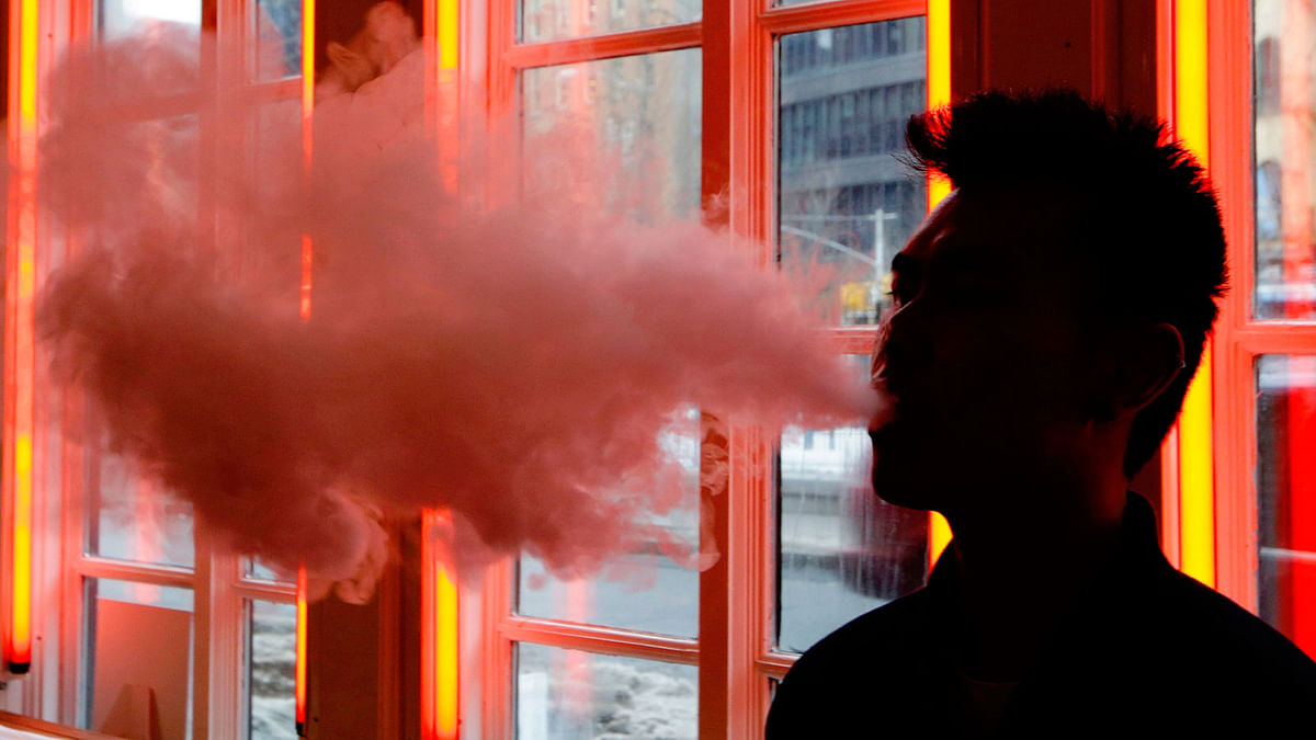In this 20 February, 2014 file photo, a customer exhales vapor from an e-cigarette at a store in New York. A growing number of e-cigarette and vaporizer sellers have started offering college scholarships as a way to get their brands listed on university websites and to get students to write essays about the potential benefits of vaping. Photo : AP