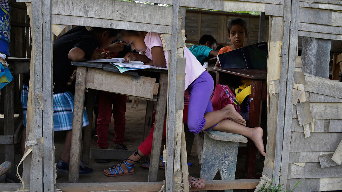 Children study at a run down school in the Amazonian shantytown of Victoria Gracia, Peru on 8 May. Photo: AP