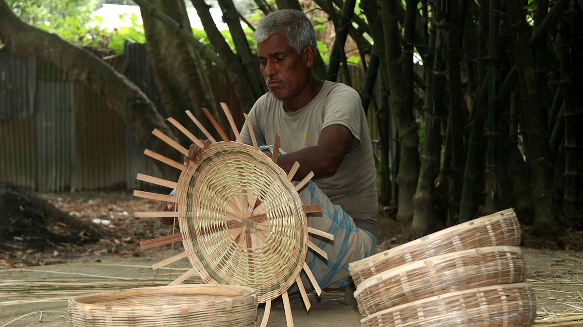 An old man weaves bamboo baskets to be sold later in market at Tk 30 each. Soel Rana took the photo from Saghatia area of Gabtali upazila in Bogura on 9 June.