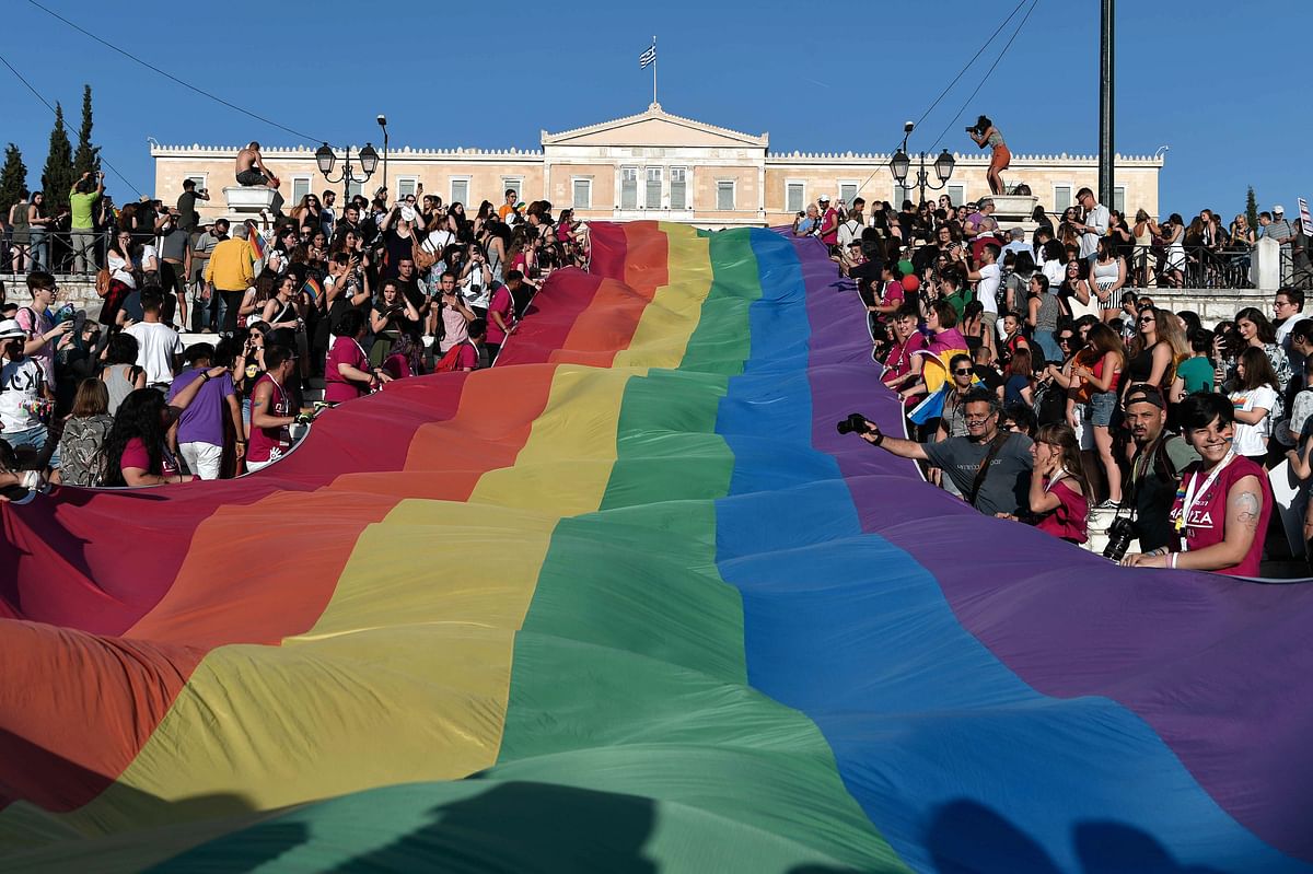 Participants of the Athens Pride hold a giant rainbow flag in front of the Greek parliament in Athens during the annual parade on 9 June. Photo: AFP
