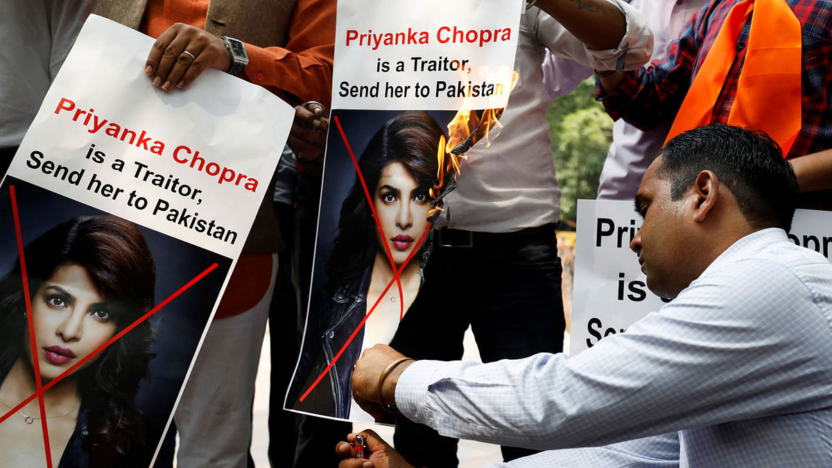 Supporters of Hindu Sena, a right wing Hindu group, burn posters of Bollywood actress Priyanka Chopra during a protest, in New Delhi, India, 9 June, 2018. Photo: Reuters