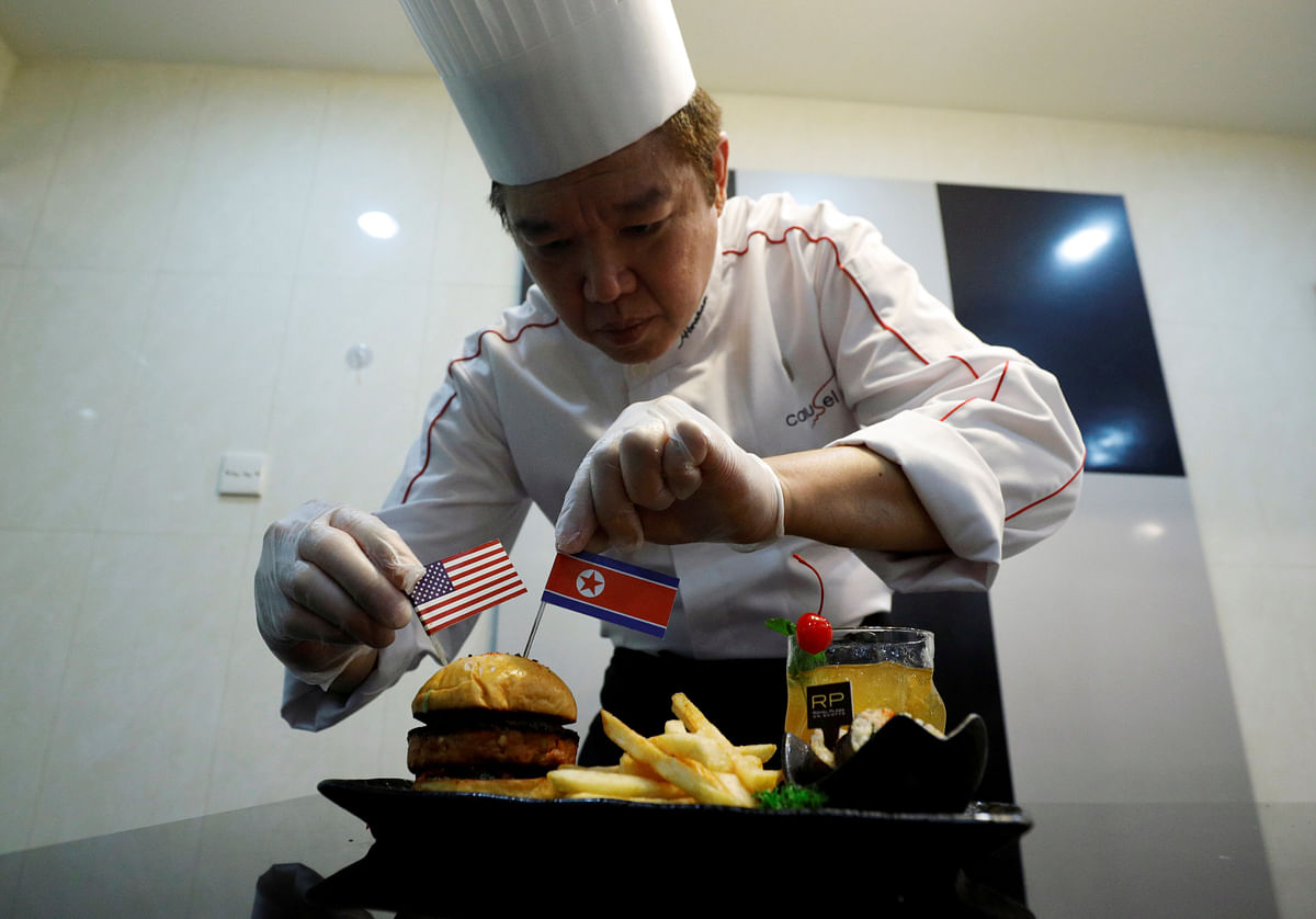 Chef Abraham Tan of Royal Plaza on Scotts` Carousel restaurant puts finishing touches to his creation, the Trump Kim burger, in Singapore on 7 June 2018. Photo: Reuters
