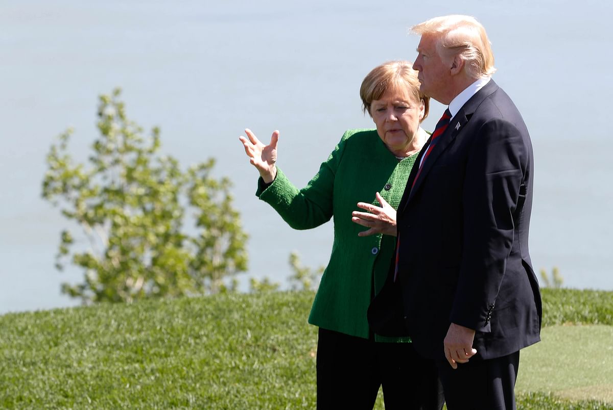 Germany’s Chancellor Angela Merkel talks with US president Donald Trump at a family photo session with the leaders of the G-7 summit in Charlevoix, Quebec, Canada on 8 June. Photo: Reuters