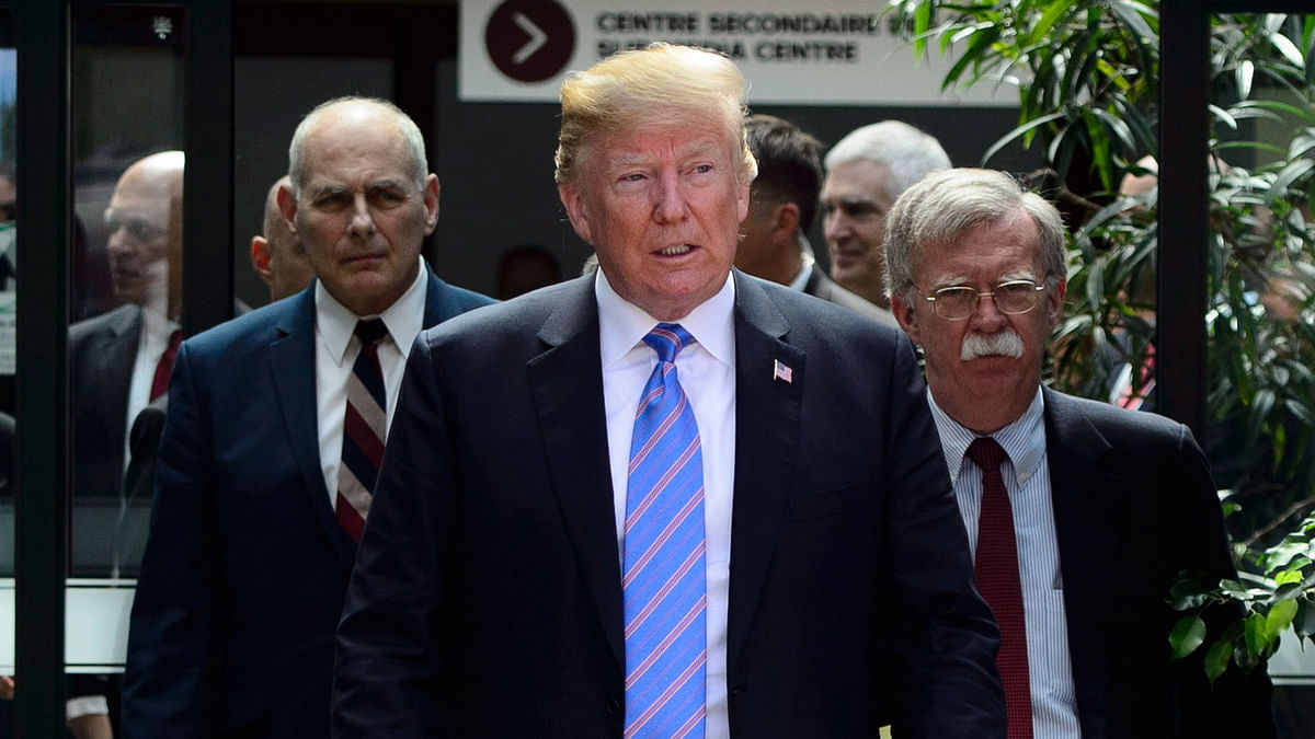 US president Donald Trump leaves the G7 Leaders Summit in La Malbaie, Quebec, on Saturday, 9 June 2018, with White House chief of Staff John Kelly, left, and national security adviser John Bolton. Photo: AP