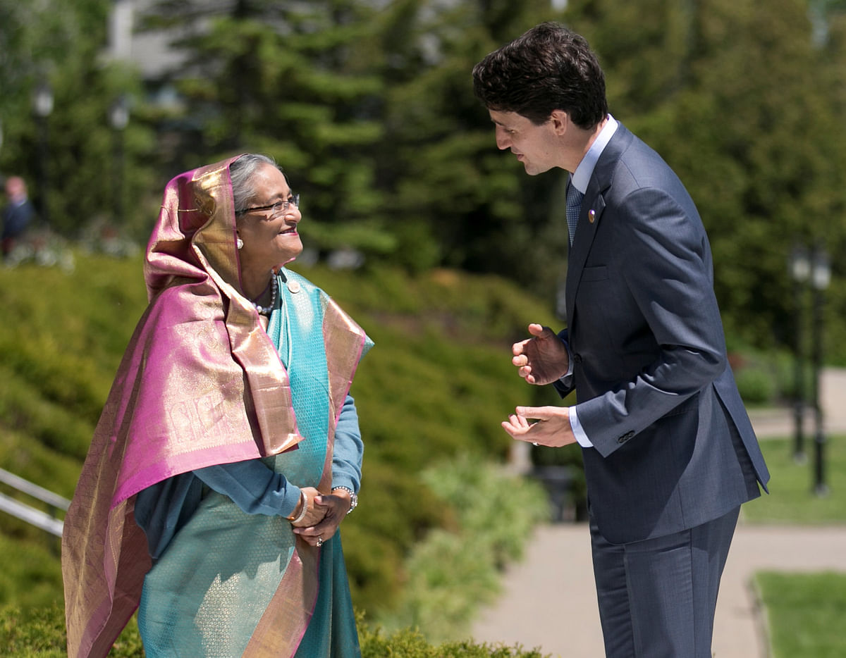 Canada`s prime minister Justin Trudeau greets Bangladesh`s prime minister Sheikh Hasina as she arrives for the official welcoming ceremony for outreach countries and international Organisations at the G7 Summit in the Charlevoix town of La Malbaie, Quebec, Canada, 9 June, 2018. Photo: Reuters