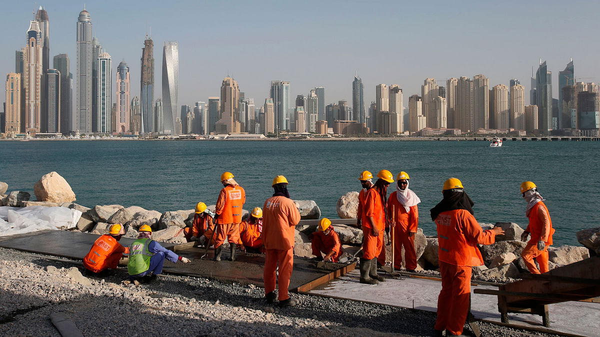 In this 22 September, 2015 file photo, laborers work at a construction site at the Palm Jumeirah, in Dubai, United Arab Emirates. A new report released Tuesday, 12 June, 2018, by the Washington-based Center for Advanced Defense Studies, relying on leaked property data from the city-state, described Dubai’s real-estate market as a haven for money launderers, terror financiers and drug traffickers sanctioned by the US in recent years. Officials in Dubai said they could not comment on the report. Photo : AP