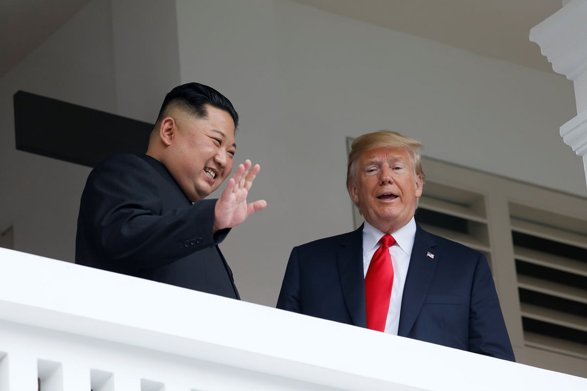 US president Donald Trump talks with North Korean leader Kim Jong Un at the Capella Hotel on Sentosa island in Singapore on 12 June. Photo: Reuters