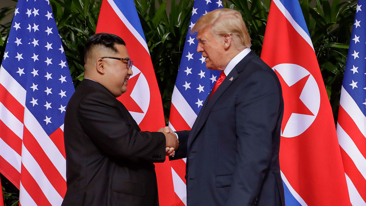 President Donald Trump makes a statement before saying goodbye to North Korea leader Kim Jong Un (L) after their meetings at the Capella resort on Sentosa Island in Singapore on 12 June 2018. Photo: AFP