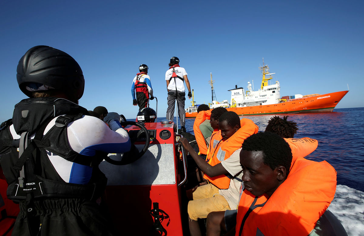 Migrants on a rubber boat are rescued by the SOS Mediterranee organisation during a search and rescue (SAR) operation with the MV Aquarius rescue ship (background) in the Mediterranean Sea, off the Libyan Coast on 14 September 2017. Photo: Reuters