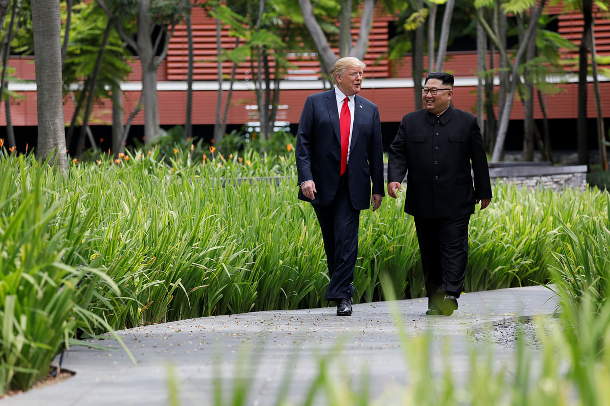 US president Donald Trump and North Korean leader Kim Jong Un walk after lunch at the Capella Hotel on Sentosa island in Singapore on 12 June. Photo: Reuters