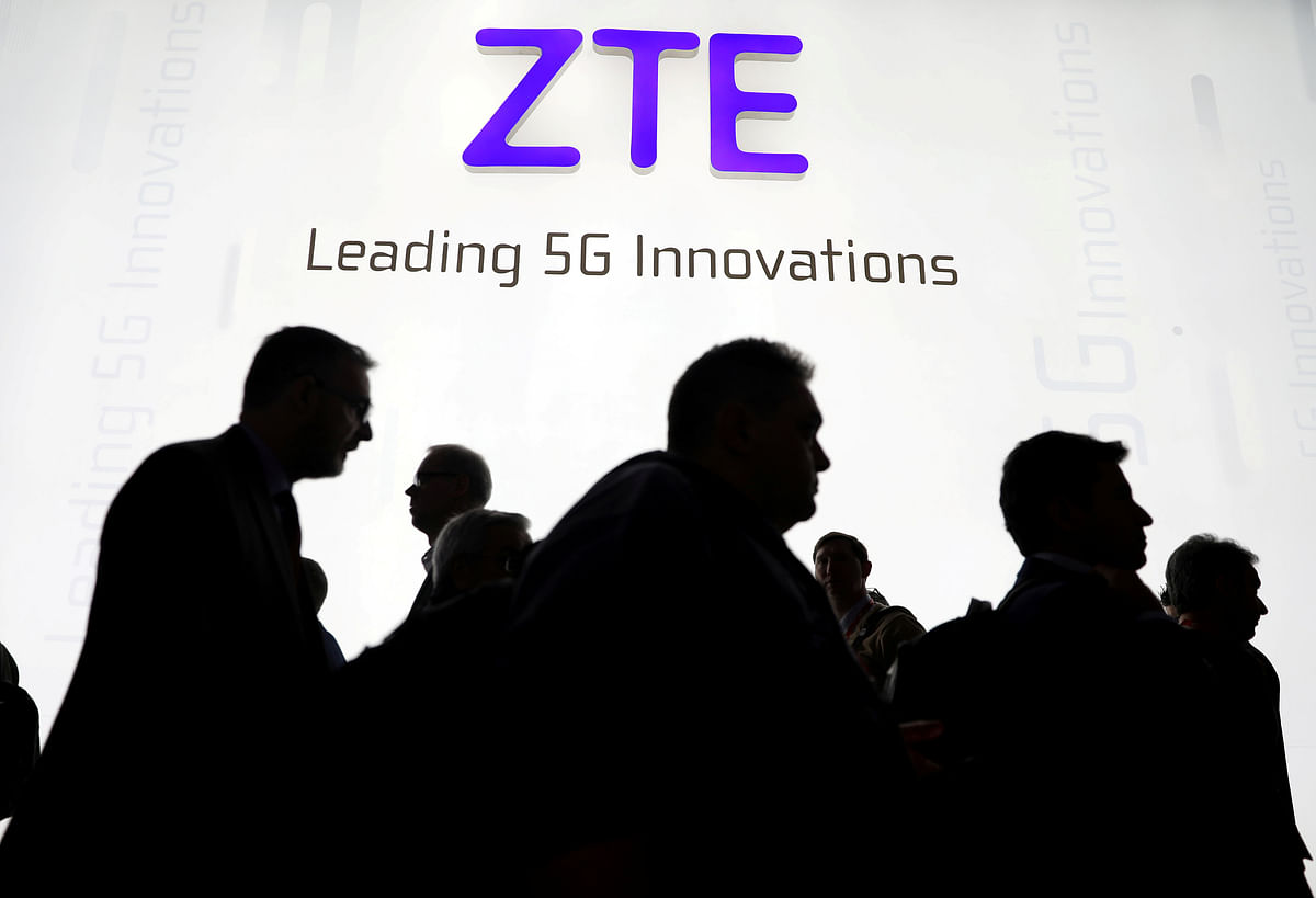 Visitors pass in front of the ZTE booth at the Mobile World Congress in Barcelona. Photo: Reuters