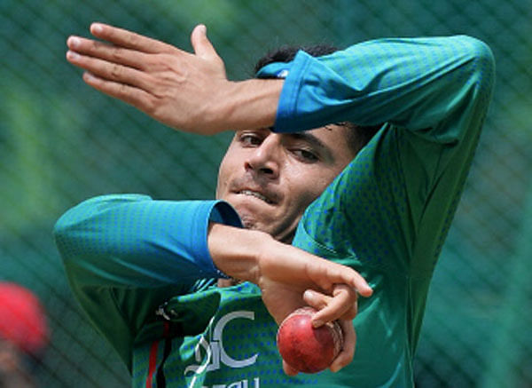 Afghanistan spinner Mujeeb-Ur-Rahman bowls in the nets during a practice session at the M. Chinnaswamy Stadium in Bangalore on 12 June, 2018. India and Afghanistan will play their one off test match in Bangalore from 14 June.