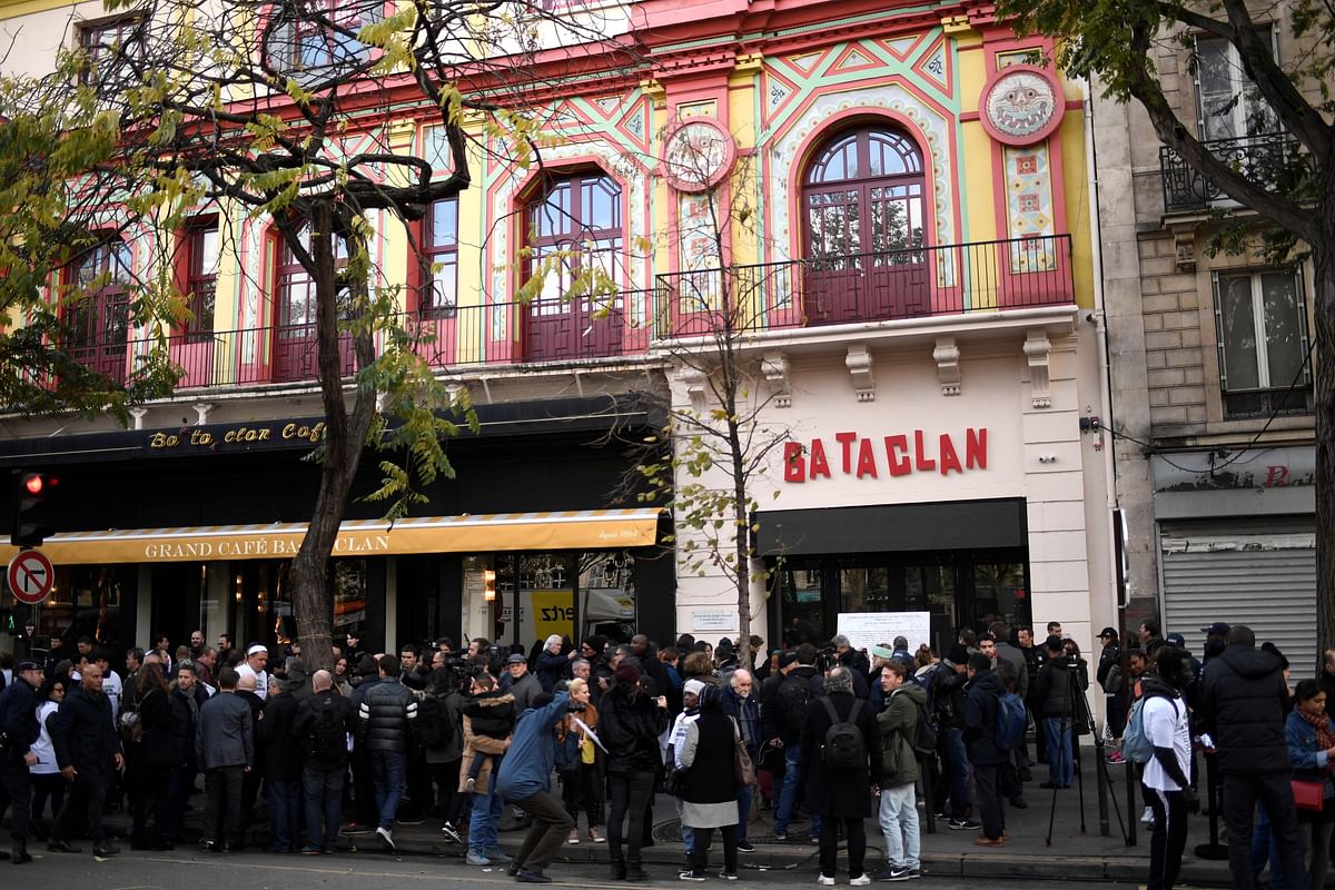In this file photo taken on November 13, 2017 people stand in front of the Bataclan concert venue during ceremonies across Paris marking the second anniversary of the terror attacks of November 2015 in which 130 people were killed, in the French capital.