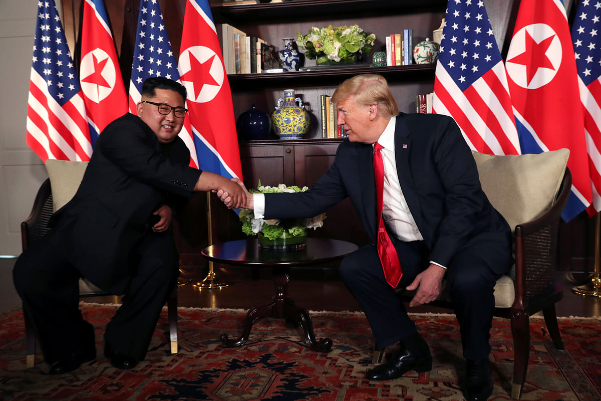 US president Donald Trump shakes hands with North Korea`s leader Kim Jong Un before their bilateral meeting at the Capella Hotel on Sentosa island in Singapore on 12 June. Photo: Reuters