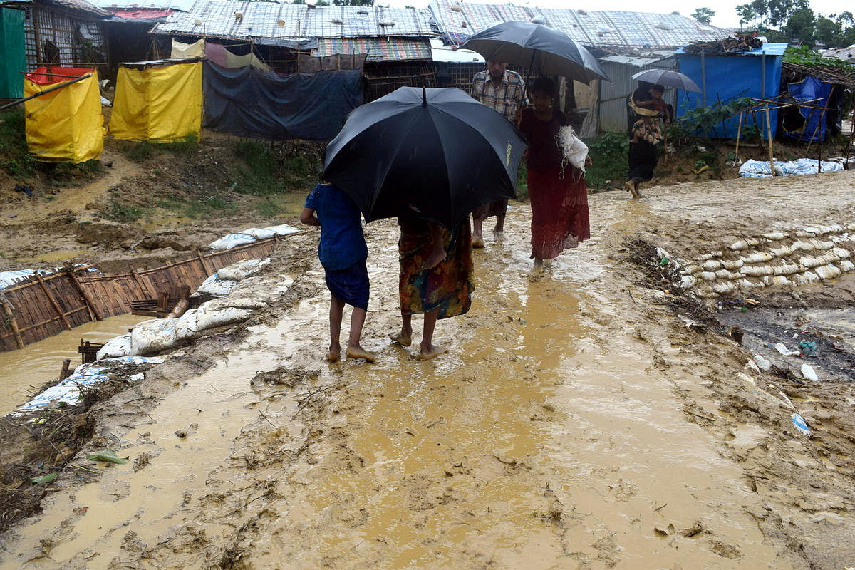 Picture taken 10 June, 2018 shows people walk after a storm at Balukhali refugee camp in Cox`s Bazar. Photo: Reuters