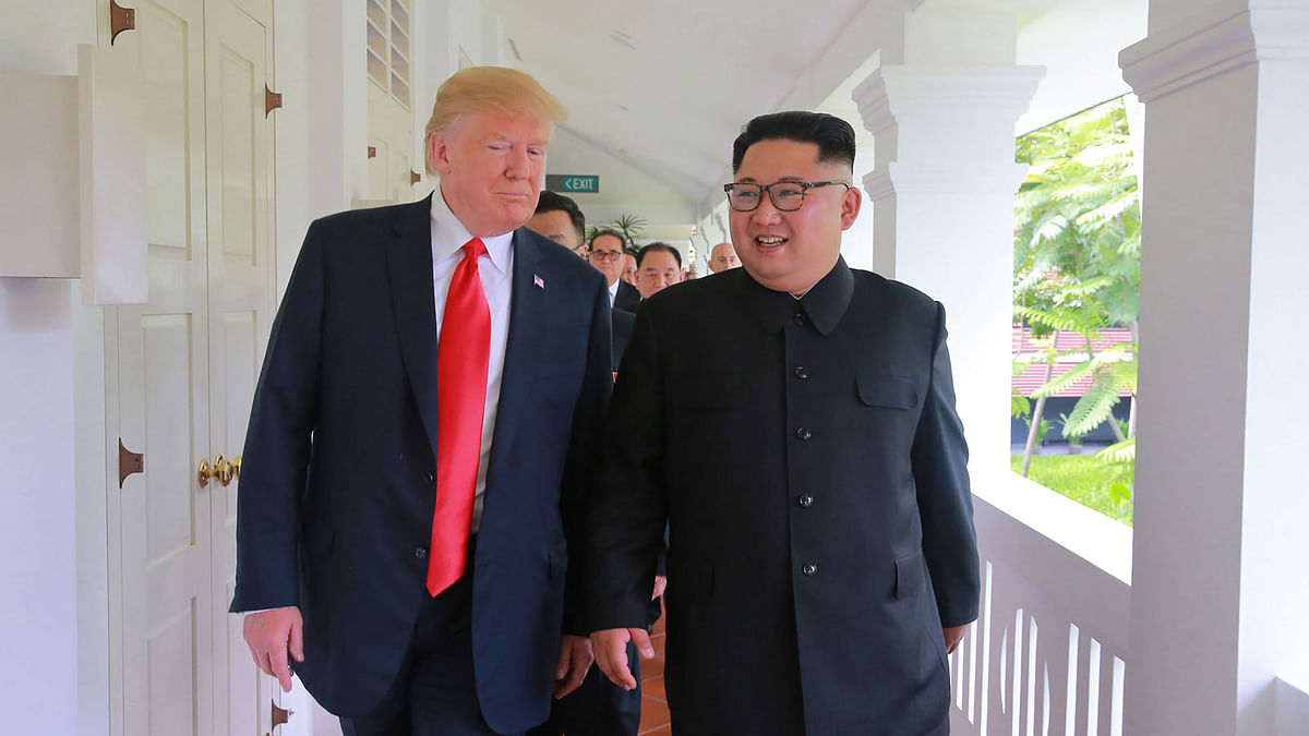 In this picture taken on 12 June 2018 and released from North Korea`s official Korean Central News Agency (KCNA) on 13 June 2018, US president Donald Trump (L) and North Korea`s leader Kim Jong Un (R) walk after a meeting during their historic US-North Korea summit, at the Capella Hotel on Sentosa island in Singapore. Photo: AFP