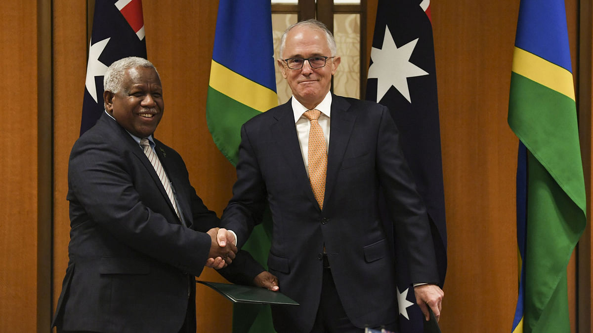Prime minister of the Solomon Islands Rick Houenipwela and Australian prime minister Malcolm Turnbull shake hands during a signing ceremony at Parliament House in Canberra, Australia on 13 June 2018. Photo: Reuters