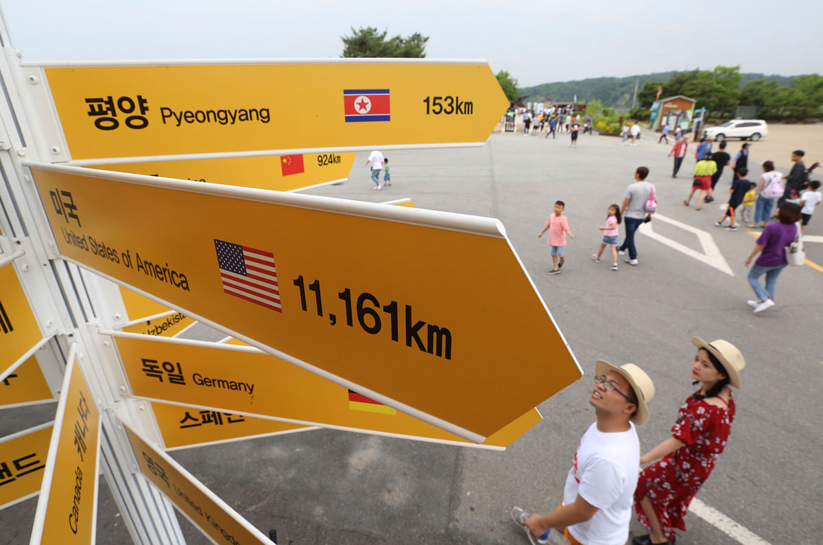 Destination signs to North Korea`s capital Pyongyang, top, and the United States, center, are seen at the Imjingak Pavilion in Paju near the border village of Panmunjom, South Korea, Wednesday, 13 June, 2018. While South Koreans cheered with hope and China saw an opening to discuss lifting sanctions on North Korea, some countries in Europe and the Mideast cautioned Tuesday that it was premature to judge US president Donald Trump and North Korean leader Kim Jong Un`s summit a success.