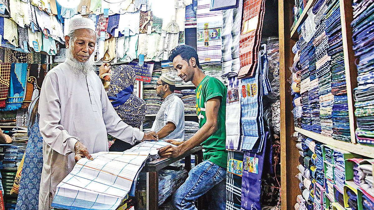 An elderly man buys a lungi in New Market, Dhaka. Photo: Prothom Alo