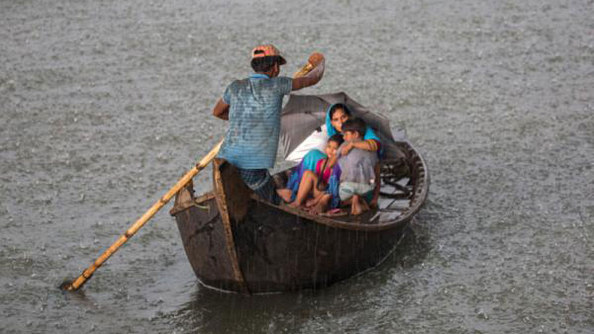 In this photo taken by Hasan Raja on 12 June on Buriganga river in Dhaka, people are seen to cross the river in risky weather without taking any safety measures. Accidents are common in such situation in the country.