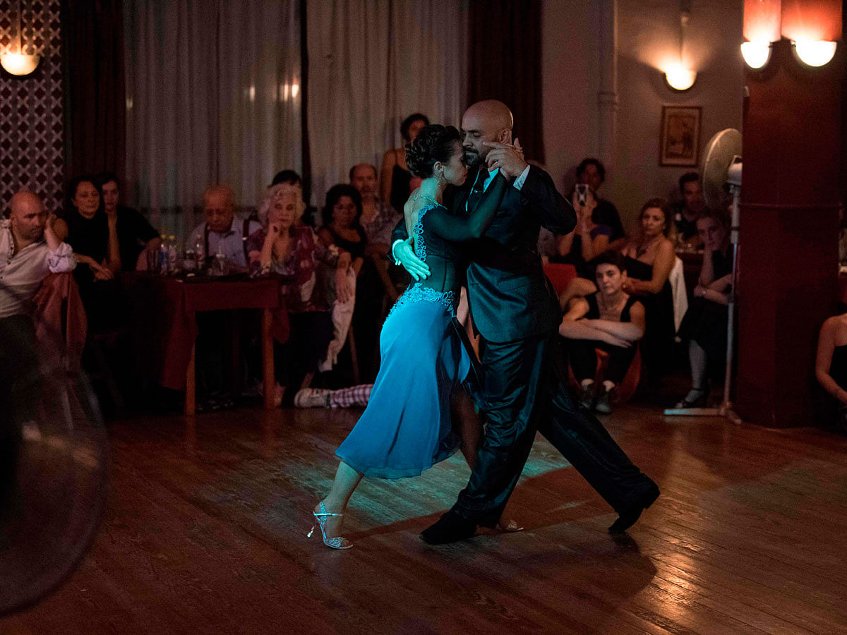 Stage tango world champion Maria Noel Sciuto (L), dances with Rodrigo Fleitas during an exhibition at Chamuyo milonga in Montevideo on 29 April 2018. The Montevideo city government is getting ready to launch a strategic plan, based on an assessment of the state of tango in Uruguay, to strengthen and revive this art form that emerged simultaneously in Buenos Aires and Montevideo in the late 19th century. Photo: AFP