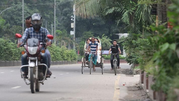 Dhaka, the city of jam, is free of the usual crowd now as many have left for home to celebrate the Eid festival. Many of the city-dwellers enjoy the time on rickshaw in jam-free roads. Minto Road, Dhaka, 13 June. Photo: Abdus Salam