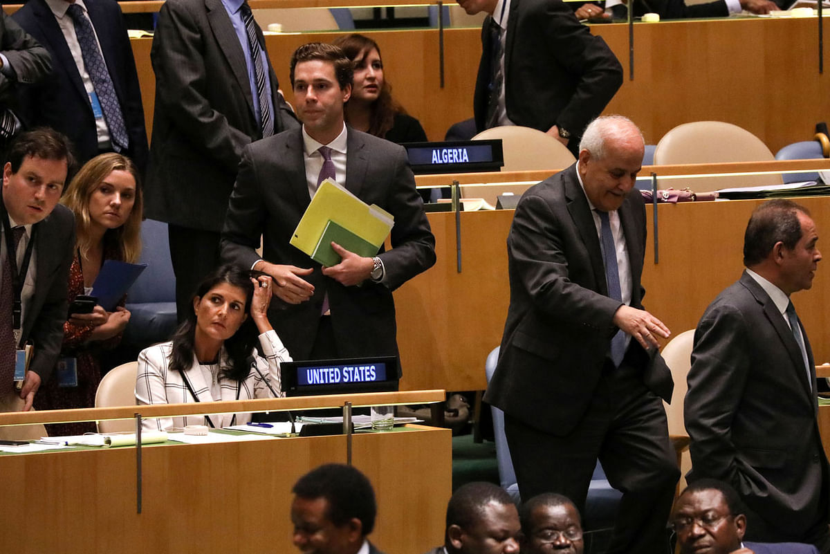 Palestinian Ambassador to the United Nations Riyad Mansour (2nd from R) passes US Ambassador Nikki Haley (seated L) during a vote on the adoption of a draft resolution by the United Nations General Assembly to deplore the use of excessive force by Israeli troops against Palestinian civilians at UN headquarters in New York, US on 13 June 2018. Photo: Reuters