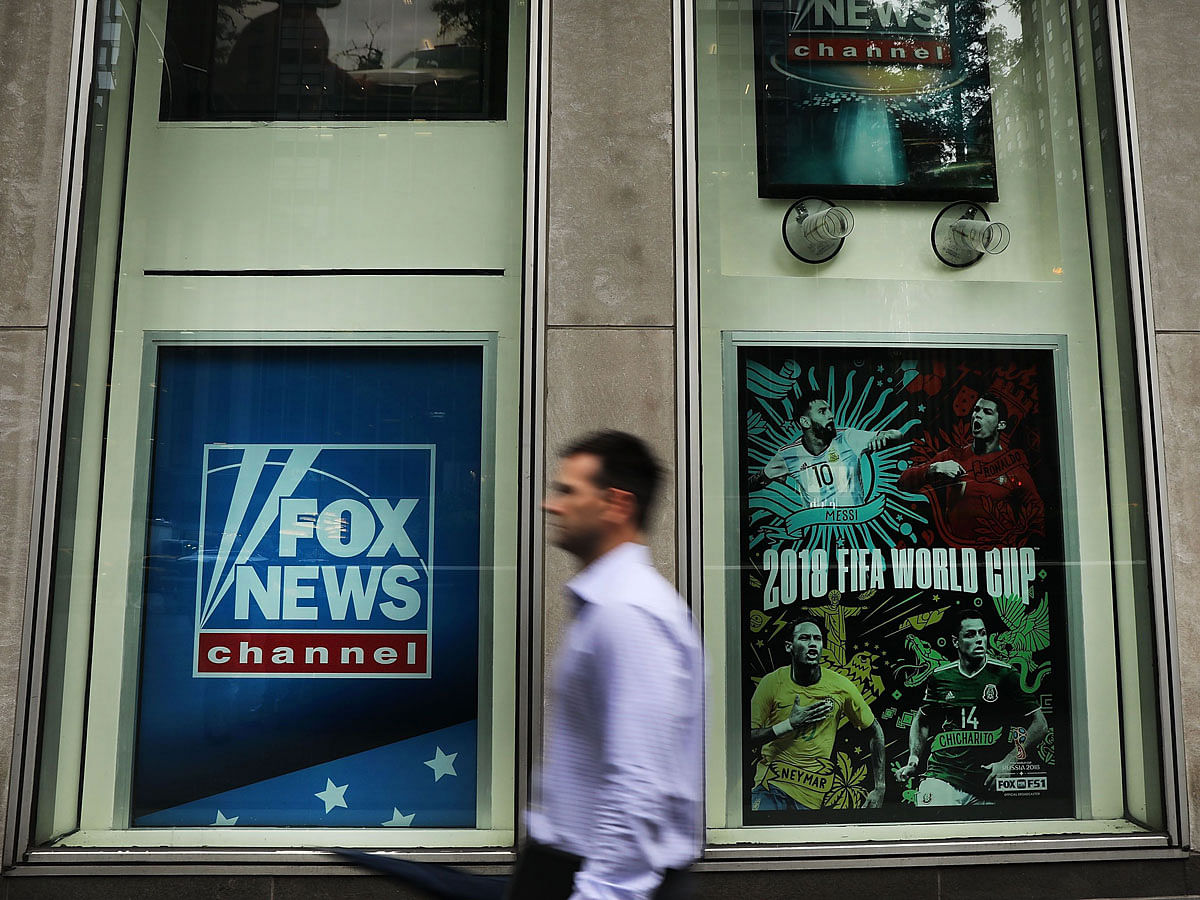 A man walks by the headquarters of 21st Century Fox on 13 June 2018 in New York City. Comcast, the giant cable operator, on Wednesday officially made a $65 billion all-cash bid for the majority of Fox. Photo: AFP
