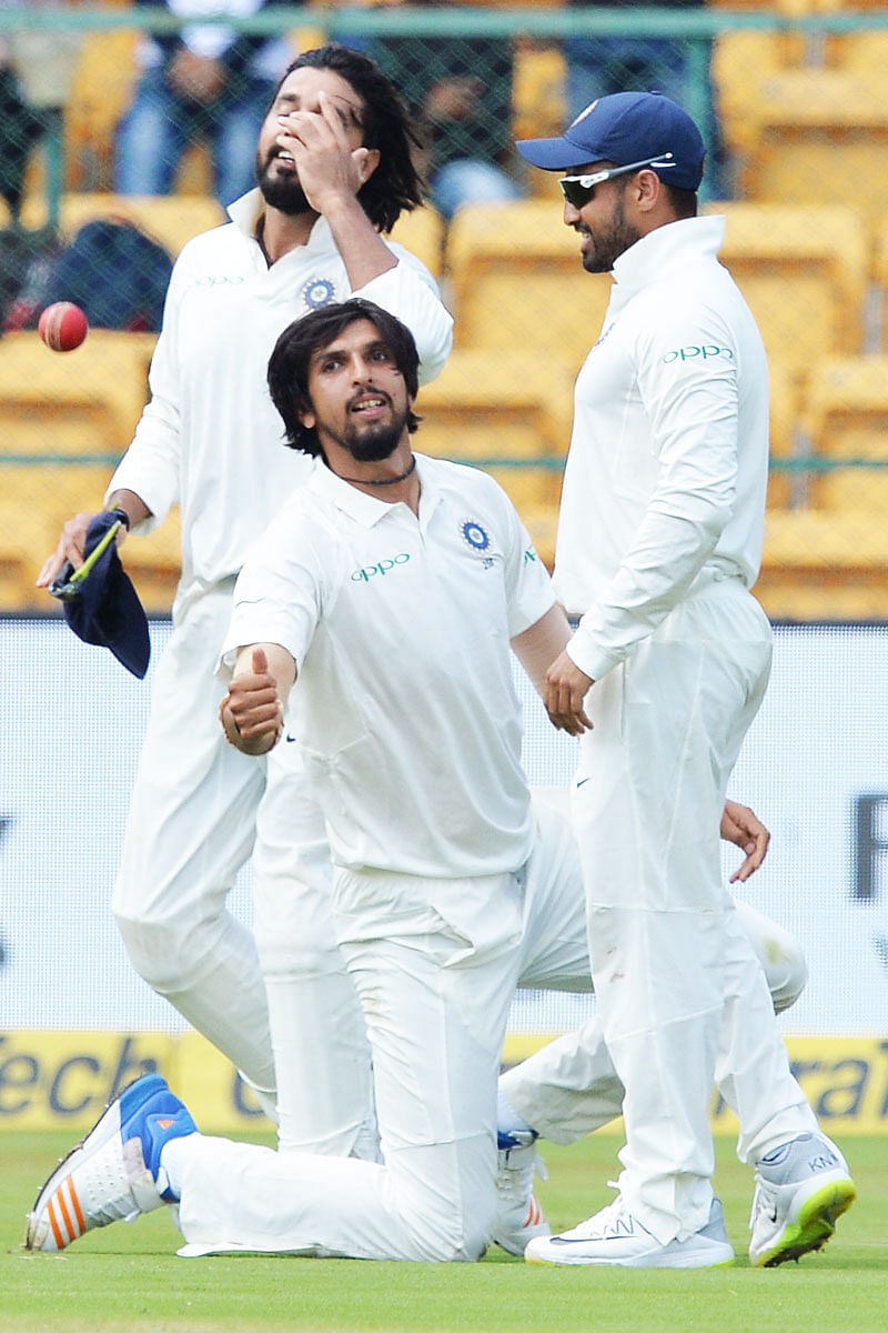 Indian cricketer Ishant Sharma (C) tosses the ball after taking a catch during the second day of one-off India Vs Afghanistan Test cricket match at The M. Chinnaswamy Stadium in Bangalore on 15 June. Photo: AFP