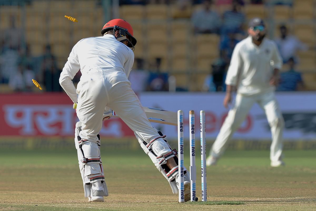 Afghanistan batsman Mohammad Yamin Ahmadzai is bowled out during the second day of one-off Test match against India at The M Chinnaswamy Stadium in Bangalore on 15 June 2018. Photo: AFP