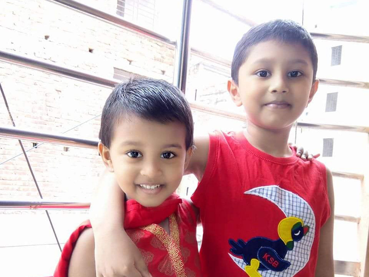 Afnan, 7, (R) and Arisha, 5, (L) from Mirpur in Dhaka are seen in their favourite red outfits. Afnan is excited about his dolphin T-shirt. Photo: Collected