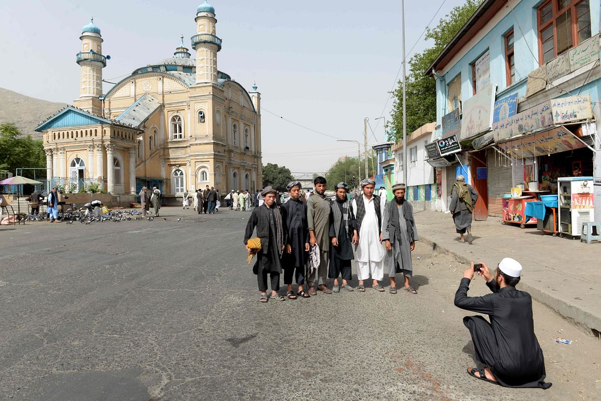 Afghans pose for a picture after offering prayers at the start of the Eid al-Fitr holiday which marks the end of Ramadan at the Shah-e Do Shamshira mosque in Kabul on 15 June Photo: AFP
